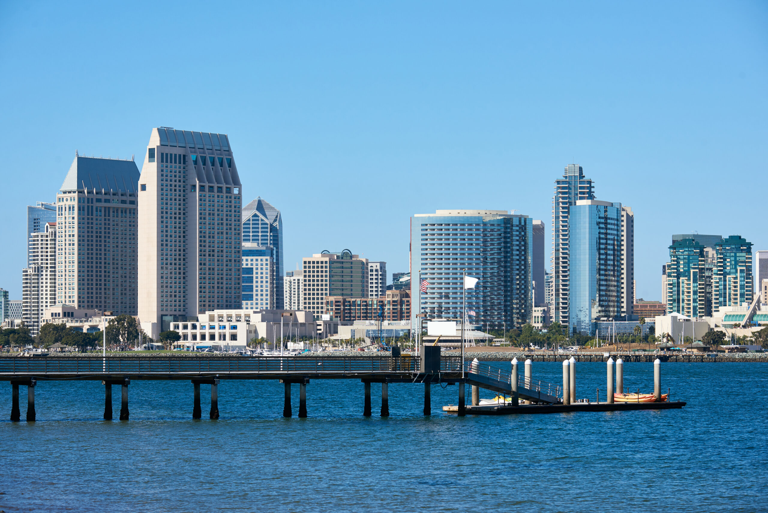 Pier with kayak boats, downtown skyline on background Miami