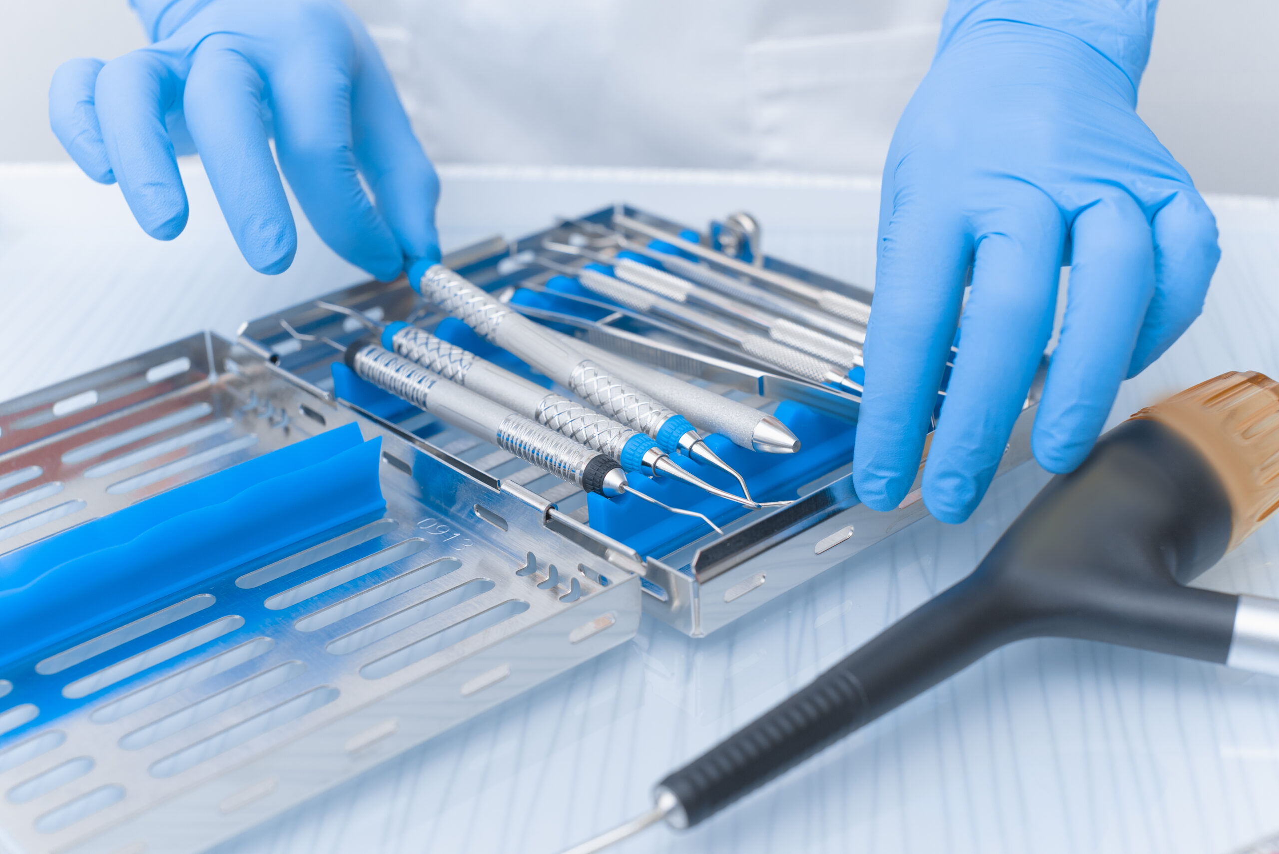 Dental tools in the hands of a doctor close-up. Pneumatic scaler. Dentistry Concept dental tools